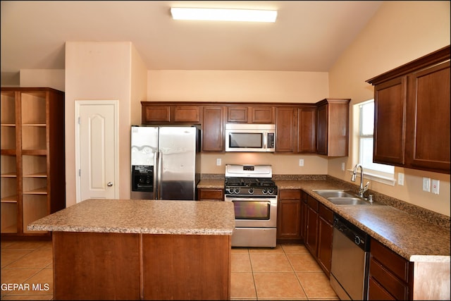 kitchen featuring sink, a center island, light tile patterned floors, and appliances with stainless steel finishes