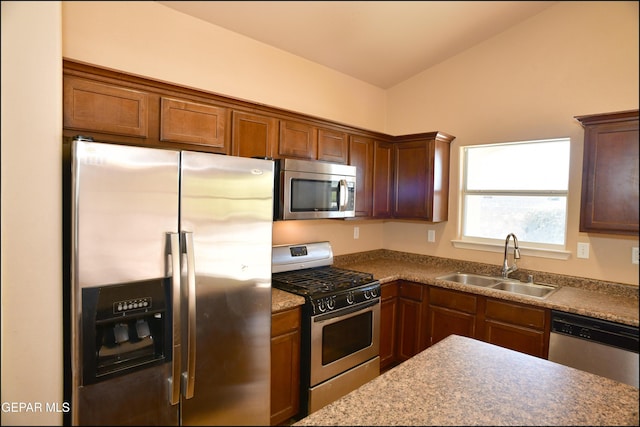 kitchen with sink, lofted ceiling, and stainless steel appliances