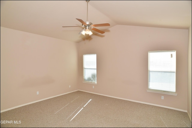 spare room featuring carpet flooring, ceiling fan, and vaulted ceiling