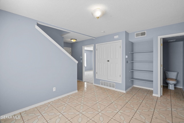 tiled foyer featuring a textured ceiling