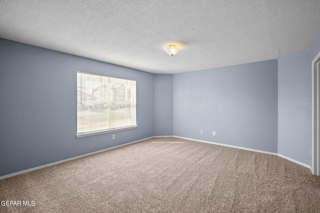 carpeted spare room featuring a textured ceiling