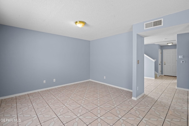 empty room featuring a textured ceiling