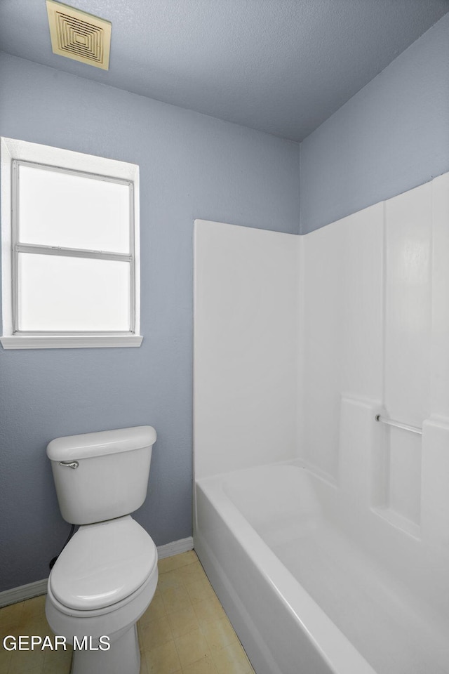 bathroom featuring toilet and a textured ceiling