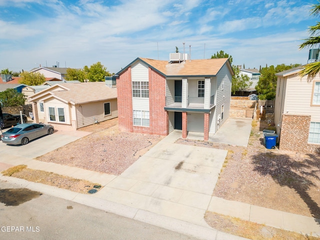 view of front of home with a balcony and a garage