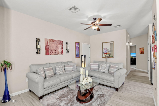 living room with light hardwood / wood-style flooring and ceiling fan