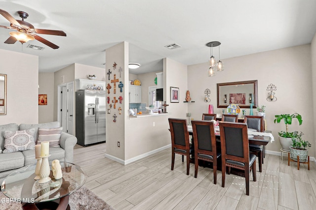 dining room with light hardwood / wood-style floors and ceiling fan