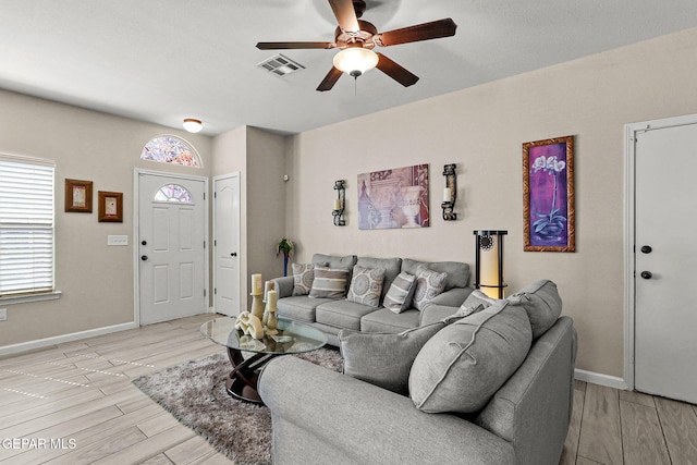 living room with light wood-type flooring and ceiling fan