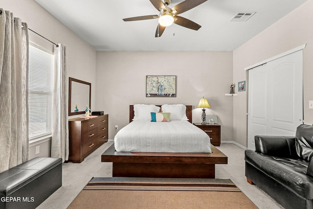 carpeted bedroom with a closet and ceiling fan