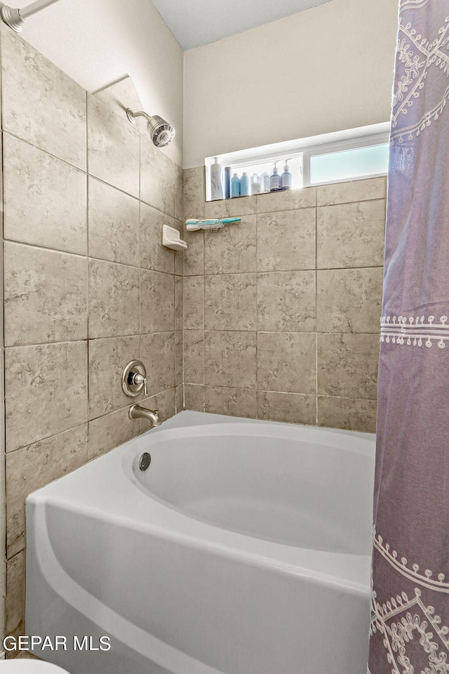 bathroom featuring shower / bathtub combination with curtain