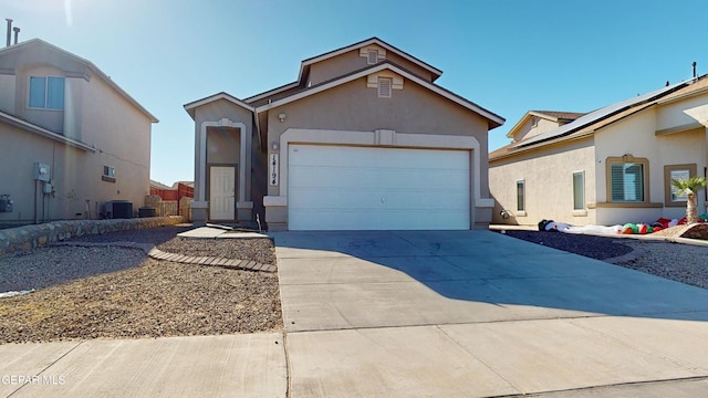 view of front of property with central AC and a garage