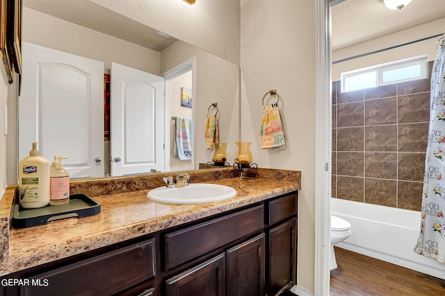 full bathroom featuring vanity, toilet, shower / bath combo with shower curtain, and hardwood / wood-style floors