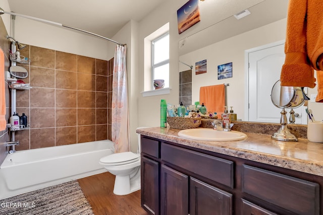 full bathroom featuring vanity, hardwood / wood-style flooring, toilet, and shower / bathtub combination with curtain