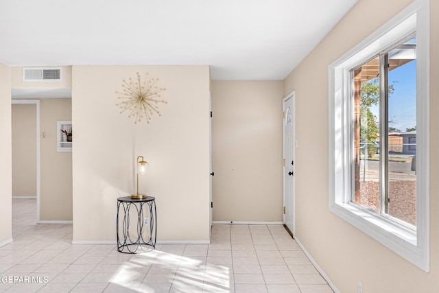 hall with light tile patterned flooring