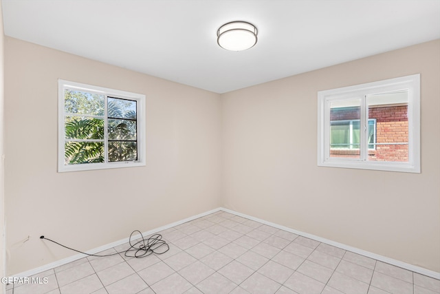 spare room featuring light tile patterned flooring