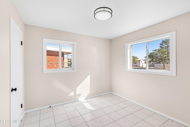 unfurnished room with a wealth of natural light and light tile patterned floors