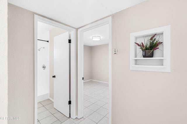 hall with light tile patterned floors