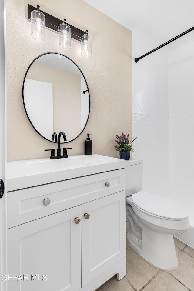 bathroom with vanity, toilet, and tile patterned flooring