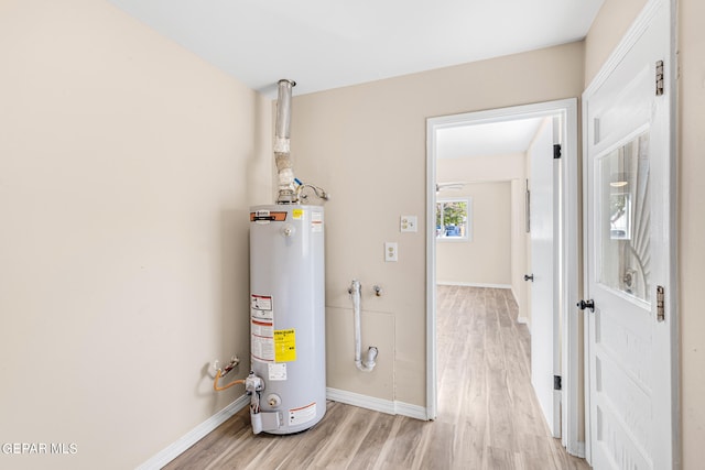 utility room featuring water heater