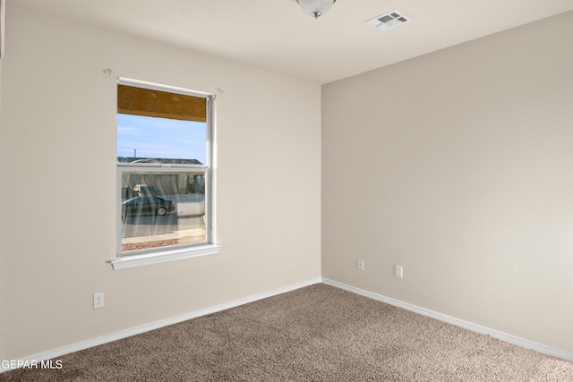 unfurnished room featuring plenty of natural light and carpet floors