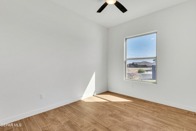 spare room featuring light wood-type flooring and ceiling fan