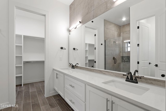 bathroom with a shower with door and vanity