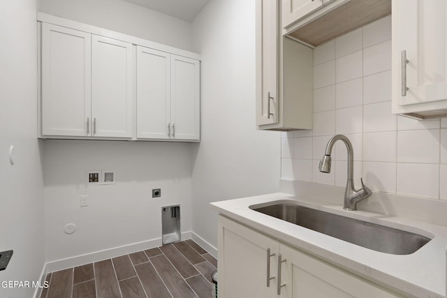 washroom with cabinets, washer hookup, dark hardwood / wood-style flooring, hookup for an electric dryer, and sink