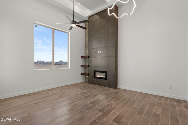 unfurnished living room with a fireplace, wood-type flooring, and ceiling fan