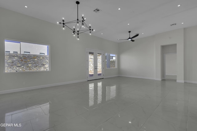 unfurnished room featuring ceiling fan with notable chandelier and french doors