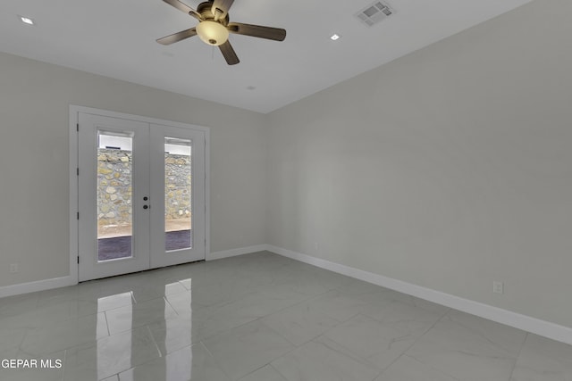 spare room featuring ceiling fan and french doors