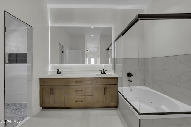 bathroom featuring vanity and tiled shower / bath