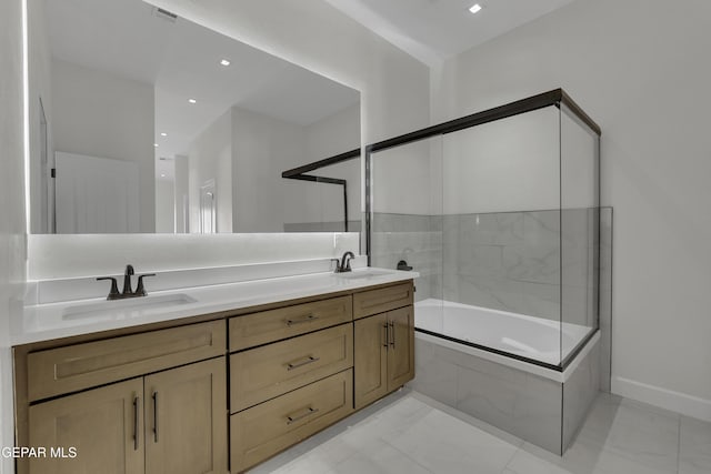 bathroom with vanity and tiled shower / bath