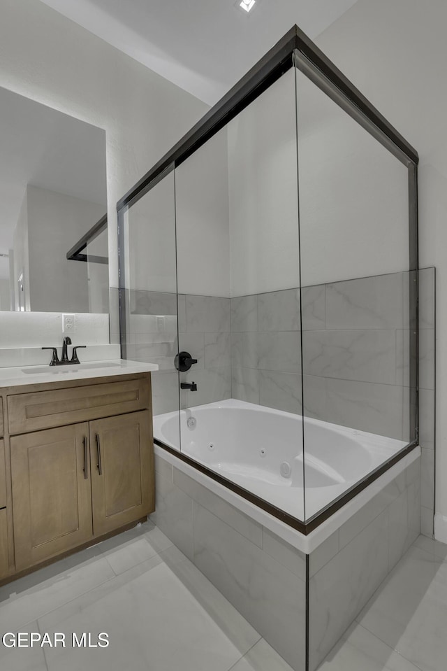 bathroom featuring vanity and tiled shower / bath