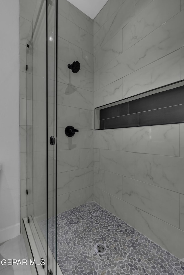 bathroom with a shower with shower door