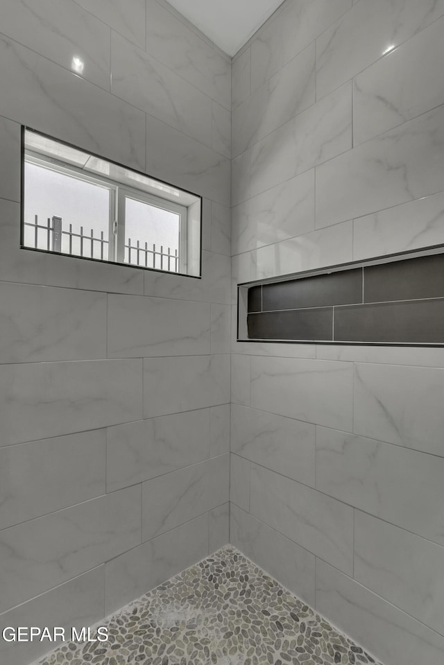 bathroom with tiled shower