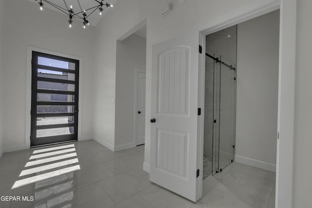 entryway with a high ceiling and an inviting chandelier