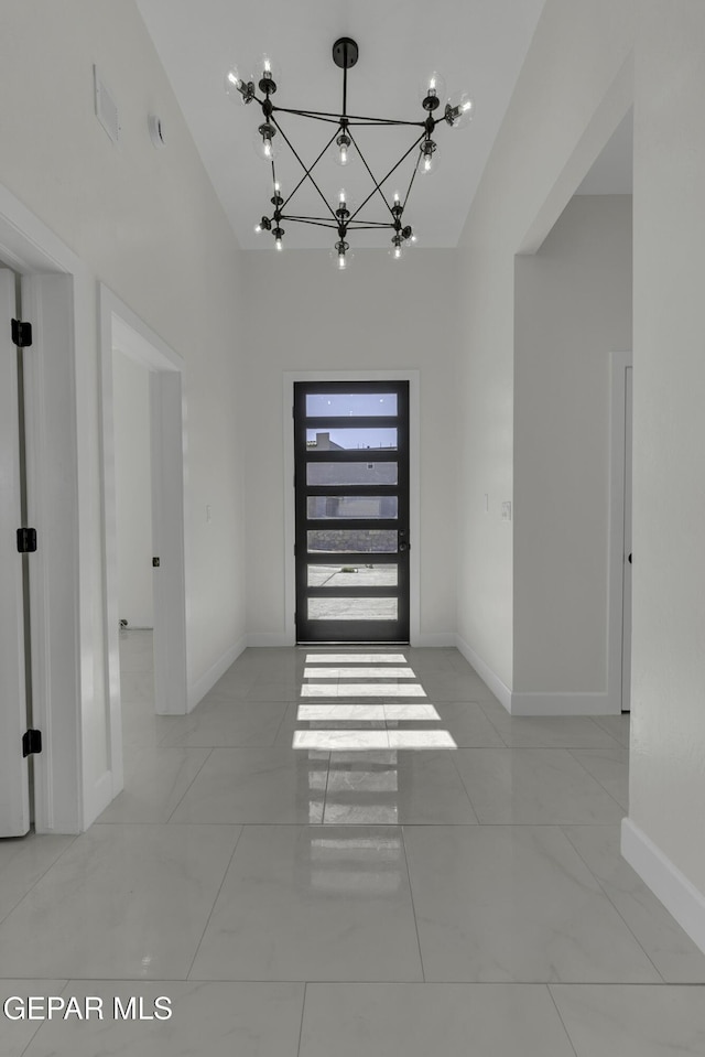 interior space featuring an inviting chandelier and a towering ceiling