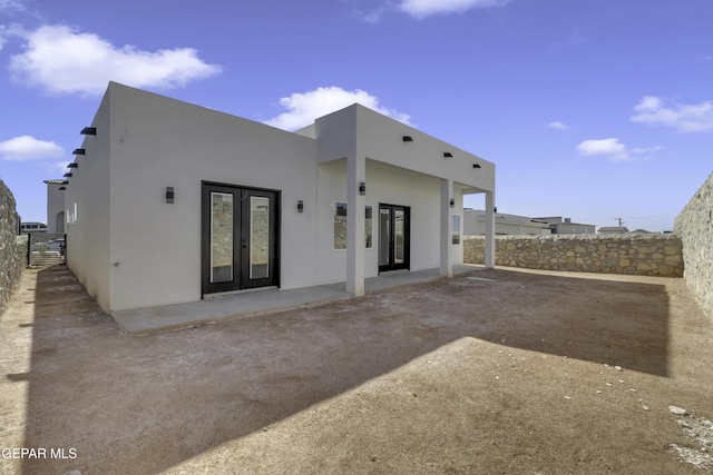 back of property featuring french doors and a patio area