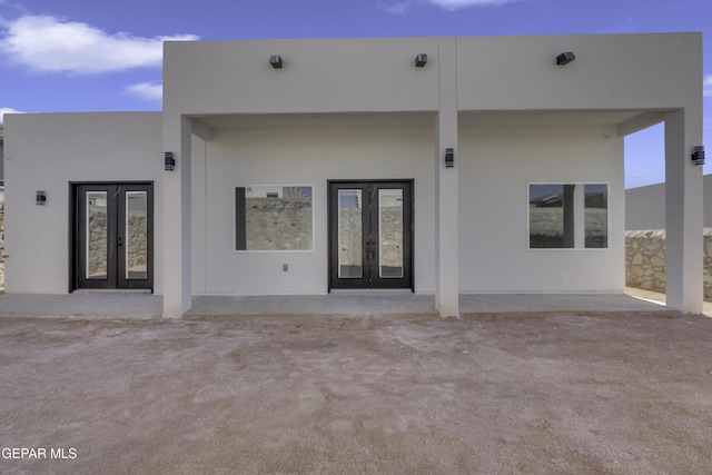 rear view of house with a patio area and french doors