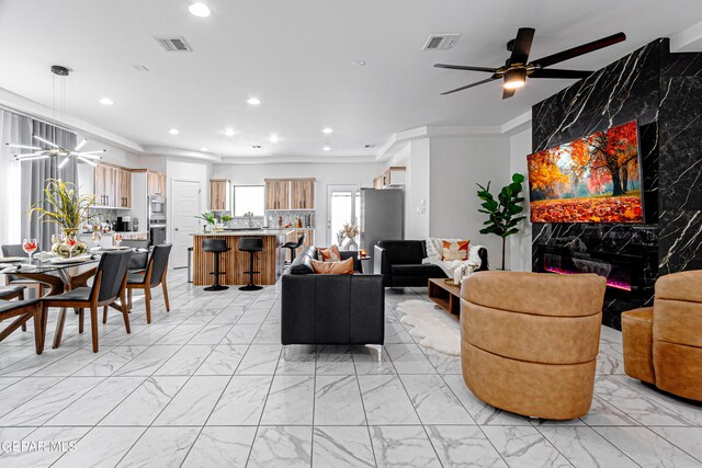 341 Sleepy Run St, El Paso, TX 79928 - living area featuring light marble finish flooring, recessed lighting, ceiling fan, and ornamental molding