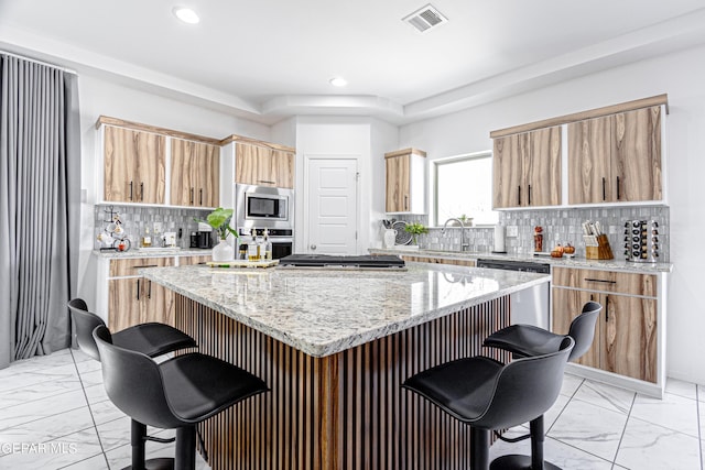 341 Sleepy Run St, El Paso, TX 79928 - kitchen with light marble finish floors, stainless steel appliances, a breakfast bar area, and recessed lighting