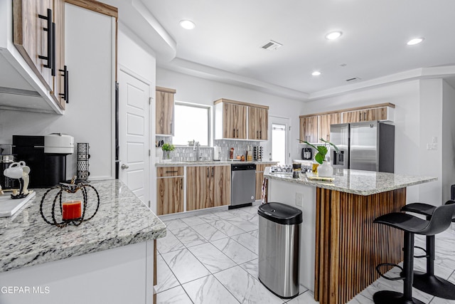 341 Sleepy Run St, El Paso, TX 79928 - kitchen featuring stainless steel appliances, light marble finish floors, a kitchen breakfast bar, recessed lighting, and a kitchen island