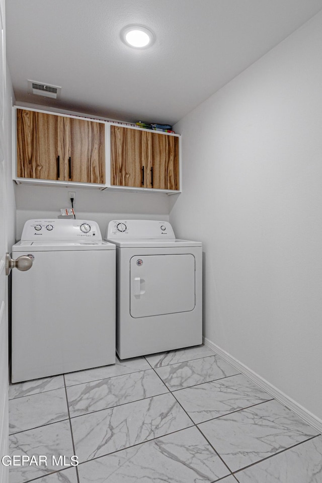 341 Sleepy Run St, El Paso, TX 79928 - clothes washing area featuring cabinet space, washer and dryer, light marble finish flooring, and baseboards