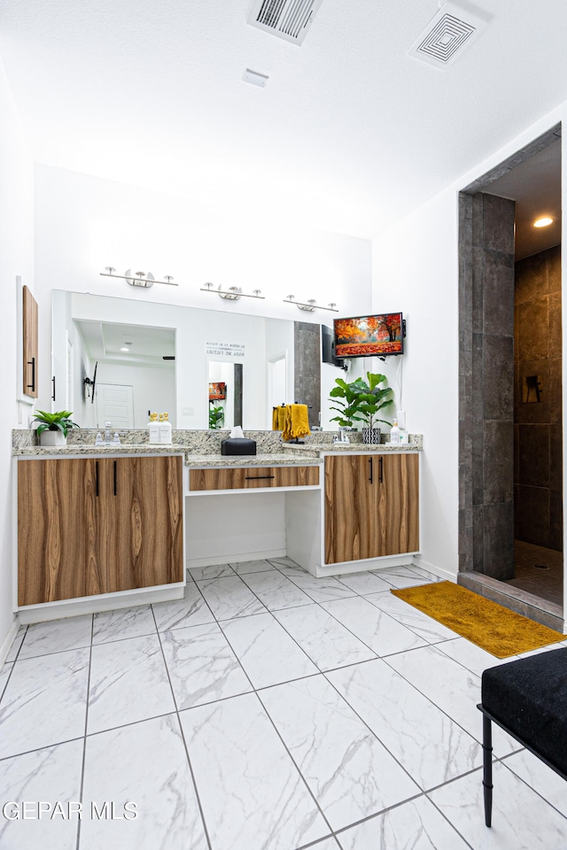 341 Sleepy Run St, El Paso, TX 79928 - full bath featuring marble look tiles, vanity, baseboards, and tiled shower