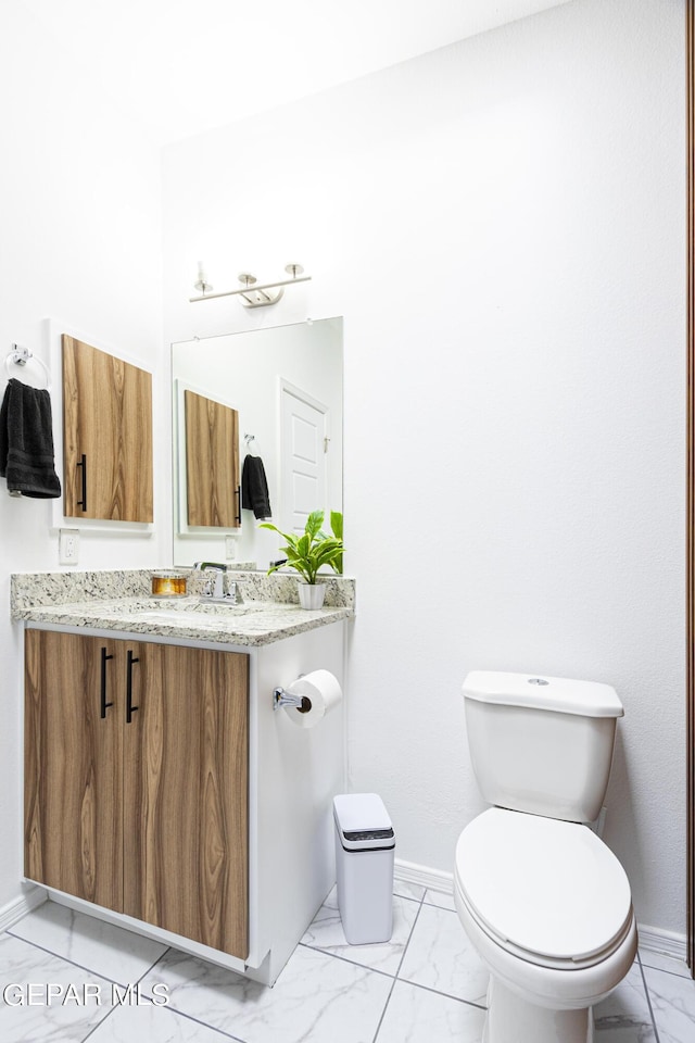 341 Sleepy Run St, El Paso, TX 79928 - bathroom with marble look tile flooring, toilet, baseboards, and vanity