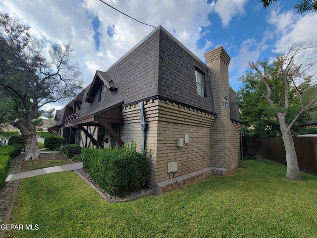 view of side of property with a lawn