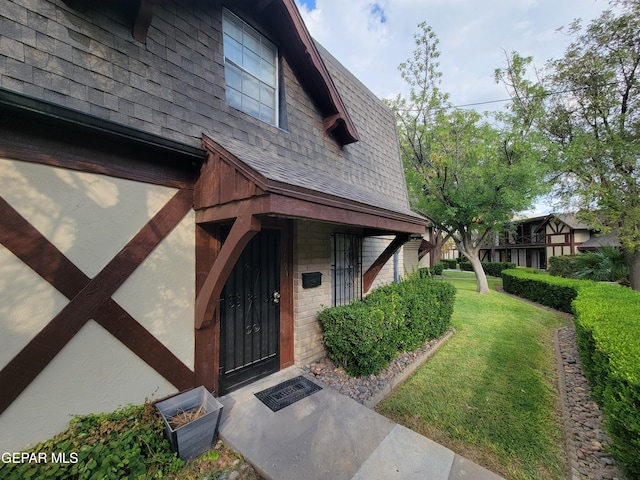 doorway to property featuring a yard