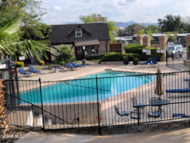 view of pool featuring a mountain view and a patio area