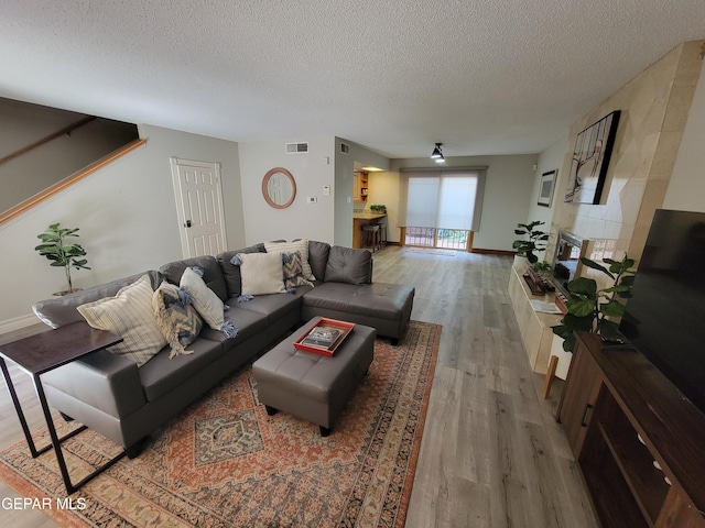 living room featuring a textured ceiling and wood-type flooring