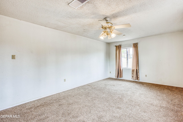 carpeted empty room featuring a textured ceiling and ceiling fan