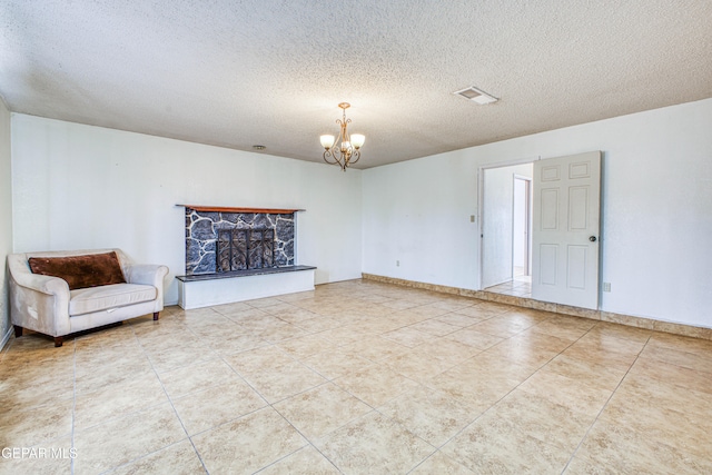 unfurnished living room with tile patterned floors, a chandelier, a stone fireplace, and a textured ceiling